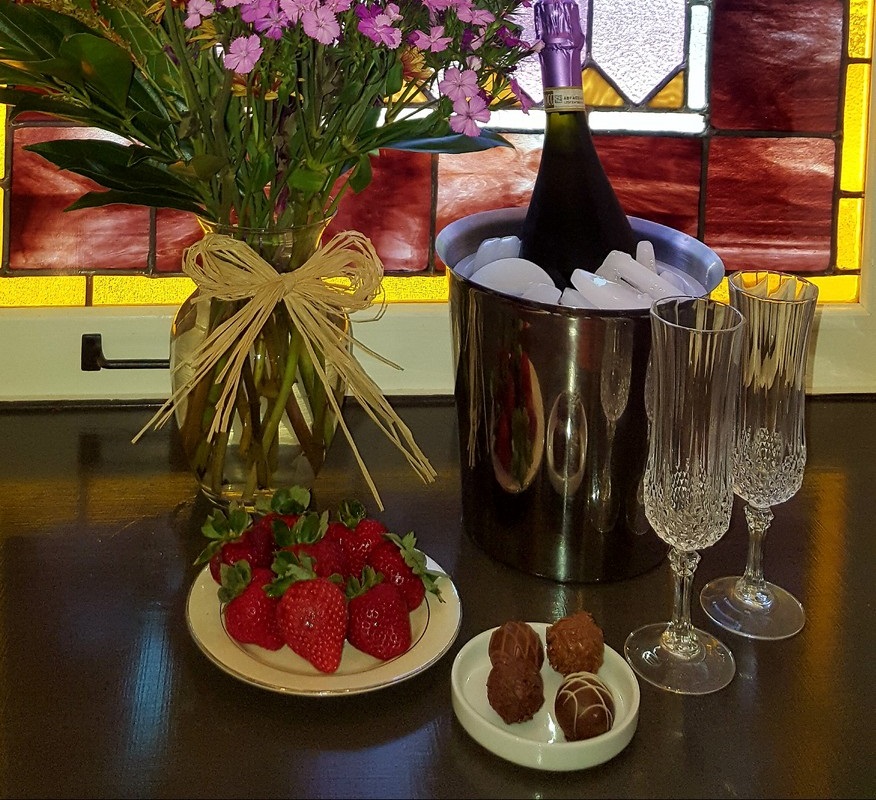 Romance package includes flowers, sparkling beverage, fruit and chocolates.