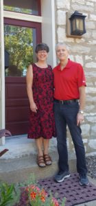 The owners of the Bed and Breakfast. Bill and Maureen Elliott stand on the office steps.